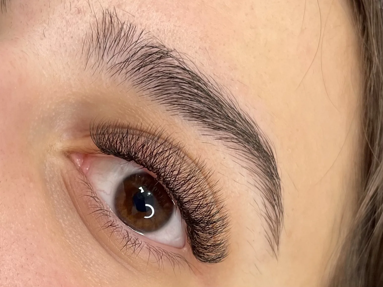 A volume set of eyelash extensions on a brown eye
