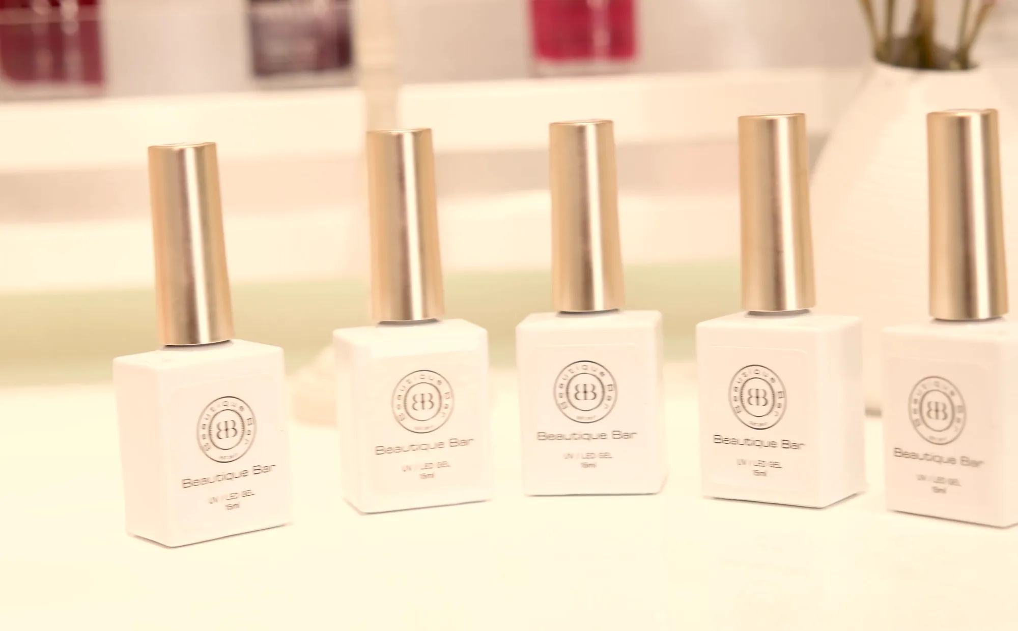 Beautique Bar own-label gel bottles with gold caps